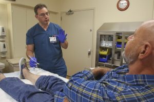 doctor with patient examining leg